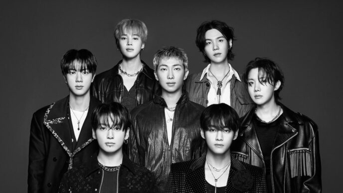 Membros do grupo BTS em apresentação, representando o modelo de negócio da Hybe.